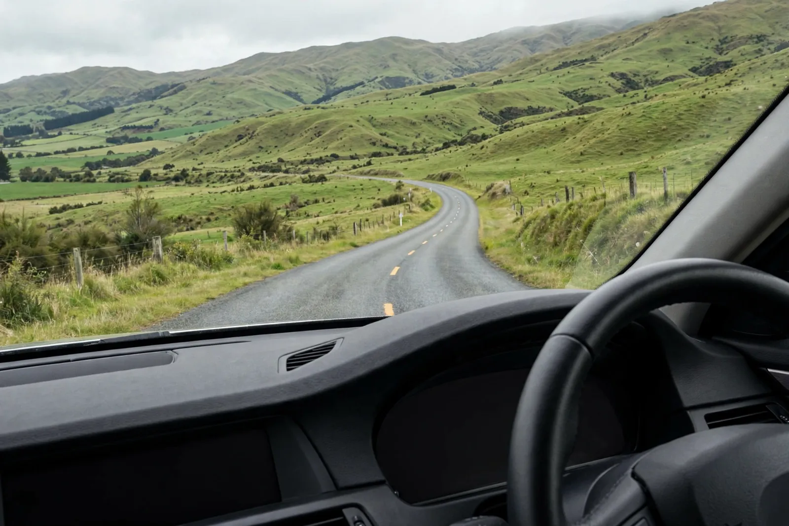 Driving on a rural New Zealand road seen from inside a car